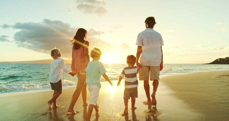 family walking down the beach